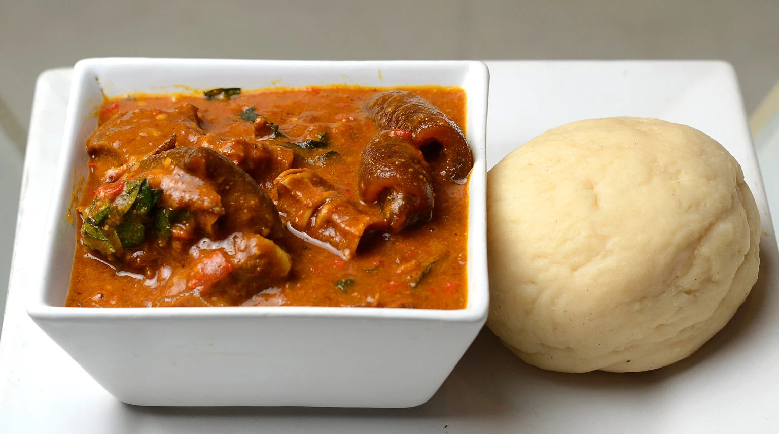 Ogbolo Soup with plate food (Soupe Ogbolo)